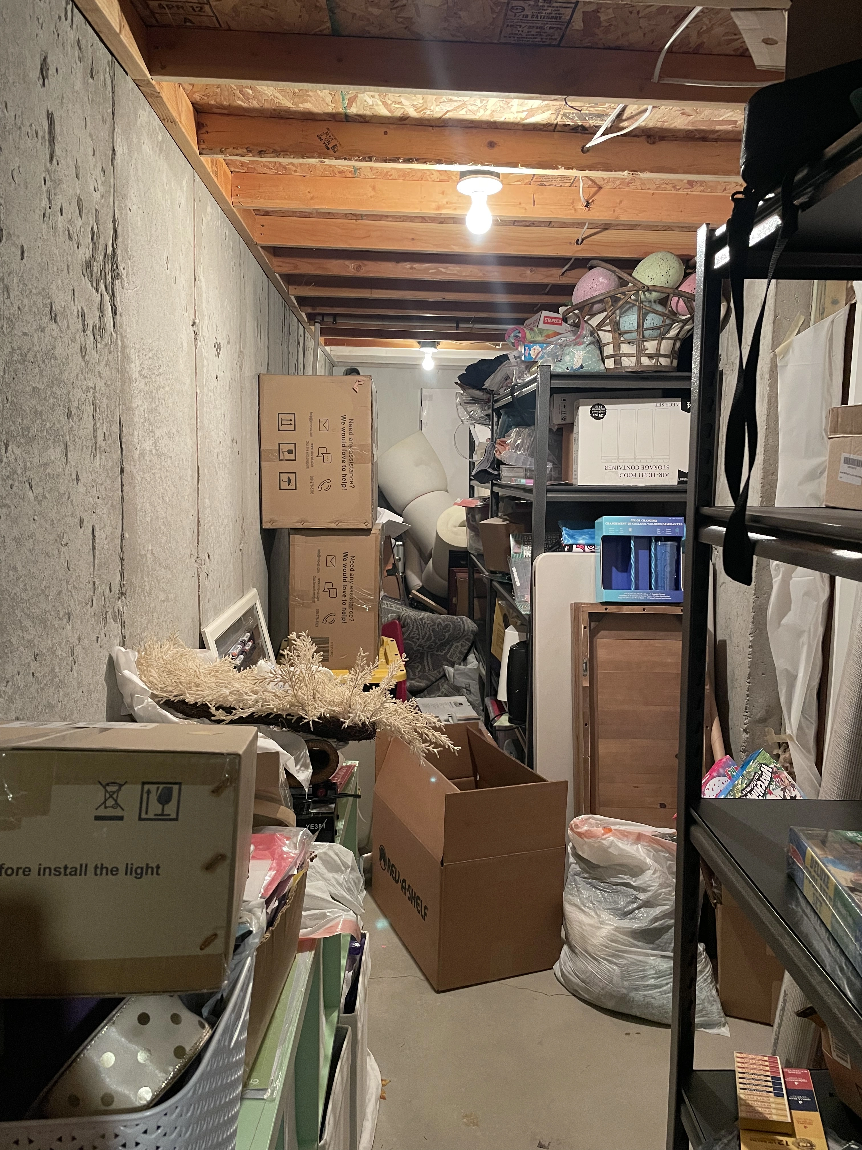 Cluttered basement storage room with boxes on the floor before ModJobs organizing in Utah